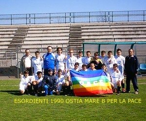 Siamo la squadra dell’OstiaMare Esordienti 1990B e da quando è iniziata la guerra In Iraq entriamo in campo portando con noi la bandiera della Pace sperando che questo massacro finisca presto. Vogliam